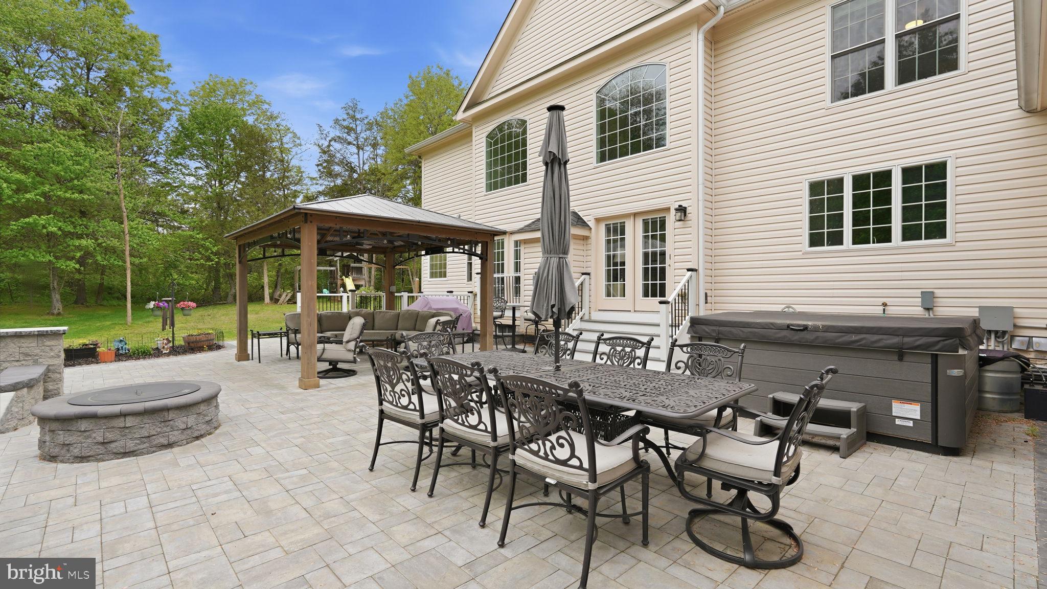 15613 Thoroughfare Road Gainesville, VA 20155 - Photo 55 of 63 a view of a patio with table and chairs and potted plants