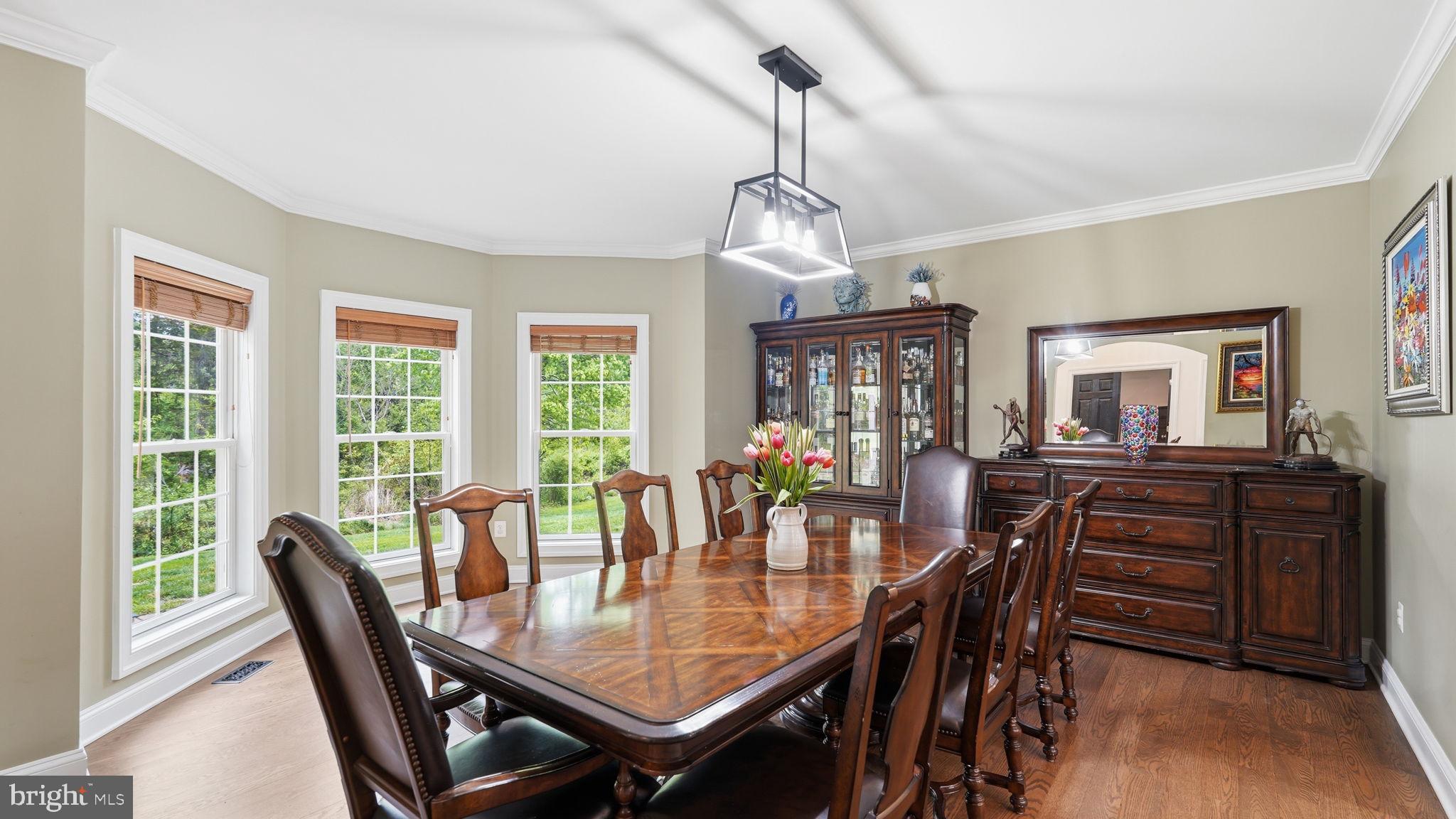 15613 Thoroughfare Road Gainesville, VA 20155 - Photo 9 of 63 a view of a dining room with furniture window and wooden floor
