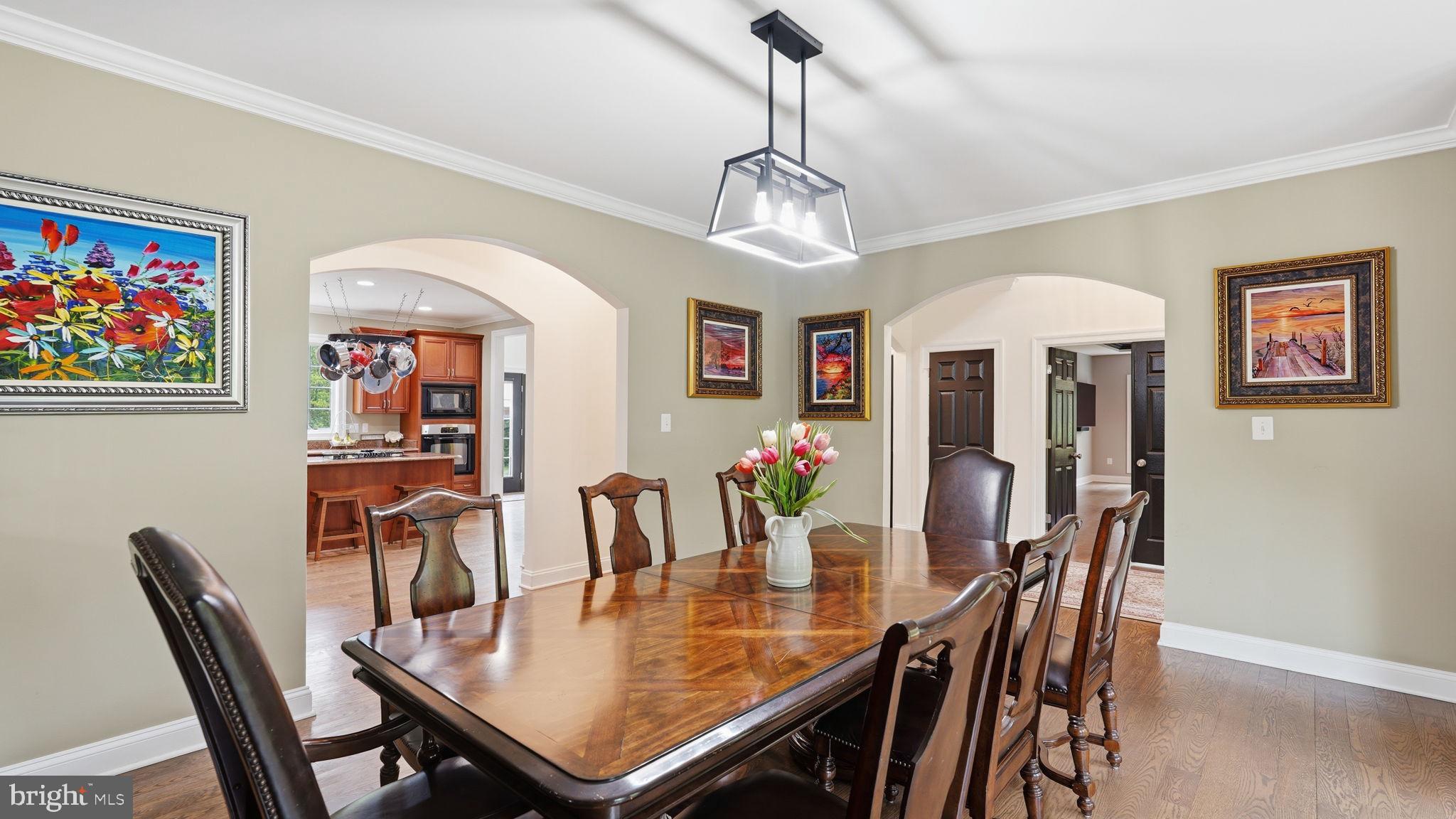 15613 Thoroughfare Road Gainesville, VA 20155 - Photo 10 of 63 a view of a dining room with furniture a chandelier and wooden floor