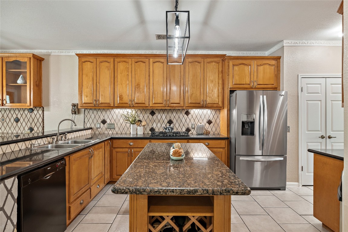 7002 Rambollet Terrace Round Rock, TX 78681 - Photo 11 of 37 a kitchen with stainless steel appliances granite countertop a sink refrigerator and cabinets