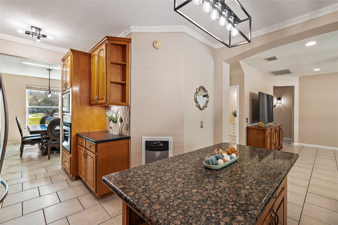 7002 Rambollet Terrace Round Rock, TX 78681 - Photo 12 of 37 a kitchen with stainless steel appliances granite countertop a sink and a refrigerator