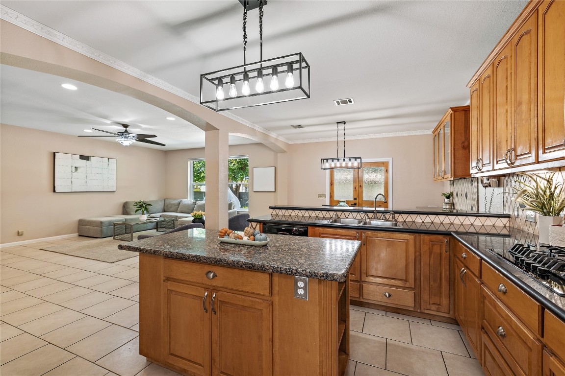 7002 Rambollet Terrace Round Rock, TX 78681 - Photo 13 of 37 a large kitchen with stainless steel appliances granite countertop a sink and cabinets