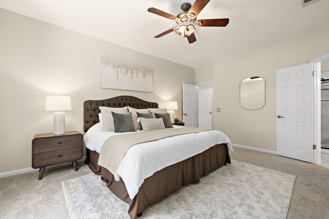 7002 Rambollet Terrace Round Rock, TX 78681 - Photo 15 of 37 a bedroom with bed and a chandelier