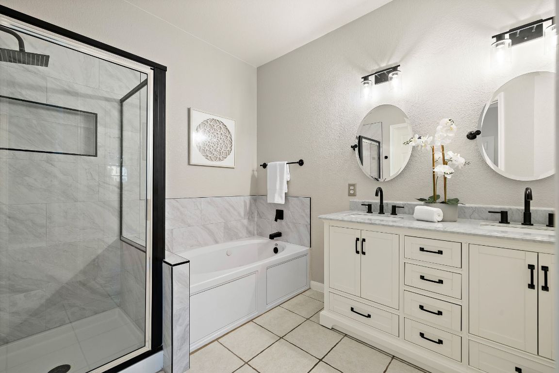 7002 Rambollet Terrace Round Rock, TX 78681 - Photo 16 of 37 a bathroom with a double vanity sink mirror and shower
