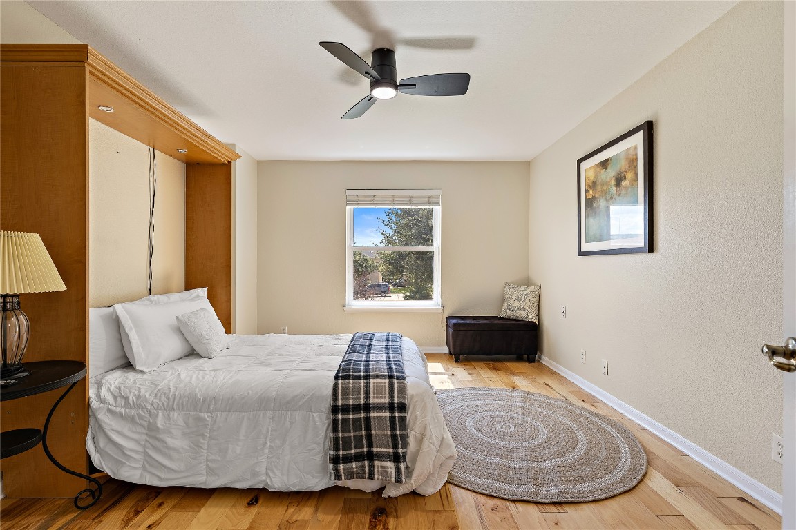 7002 Rambollet Terrace Round Rock, TX 78681 - Photo 23 of 37 a bedroom with a bed and wooden floor