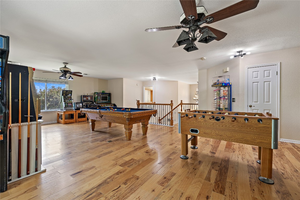 7002 Rambollet Terrace Round Rock, TX 78681 - Photo 26 of 37 a view of a living room and kitchen with furniture wooden floor and chandelier