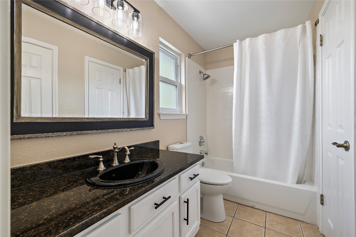 7002 Rambollet Terrace Round Rock, TX 78681 - Photo 29 of 37 a bathroom with a granite countertop sink and a mirror