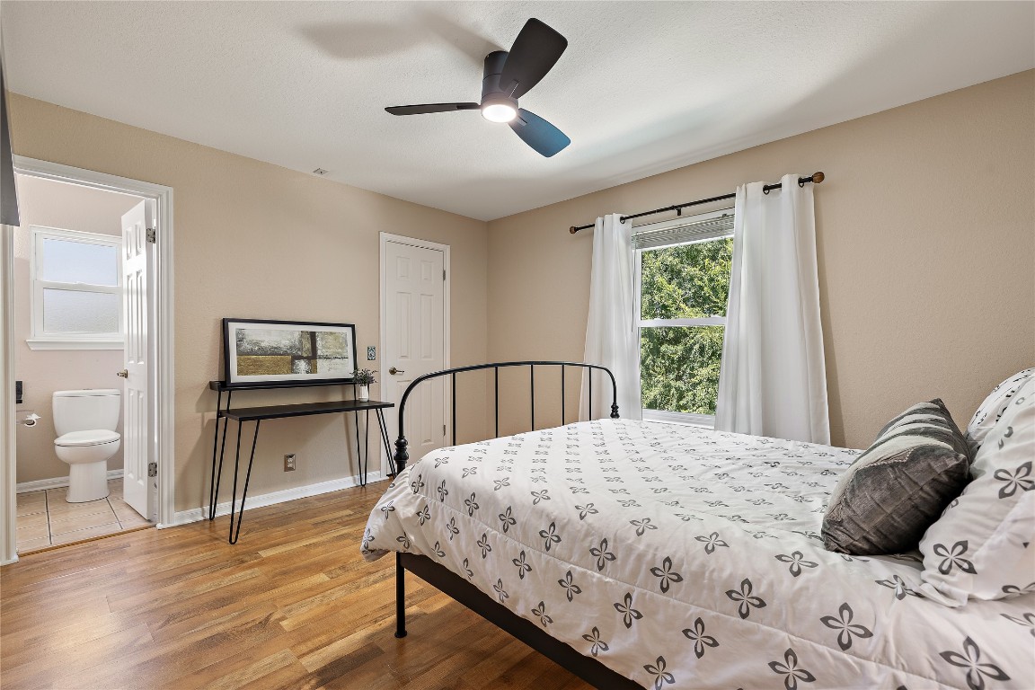 7002 Rambollet Terrace Round Rock, TX 78681 - Photo 30 of 37 a bedroom with a bed a large window and wooden floor