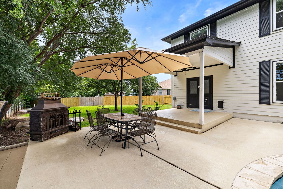7002 Rambollet Terrace Round Rock, TX 78681 - Photo 34 of 37 a view of a patio with a table and chairs under an umbrella