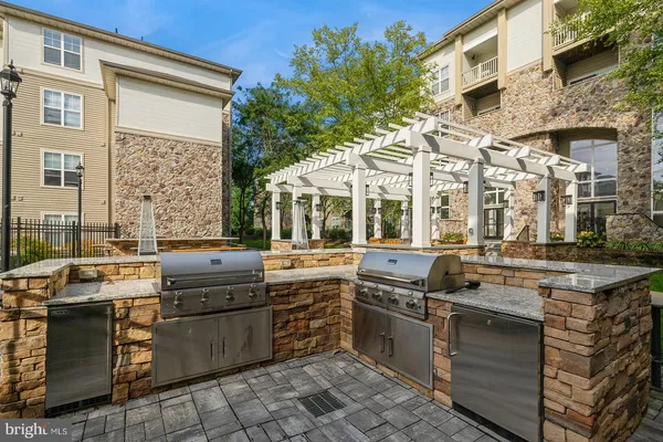a view of a kitchen with stainless steel appliances granite countertop a stove and a sink