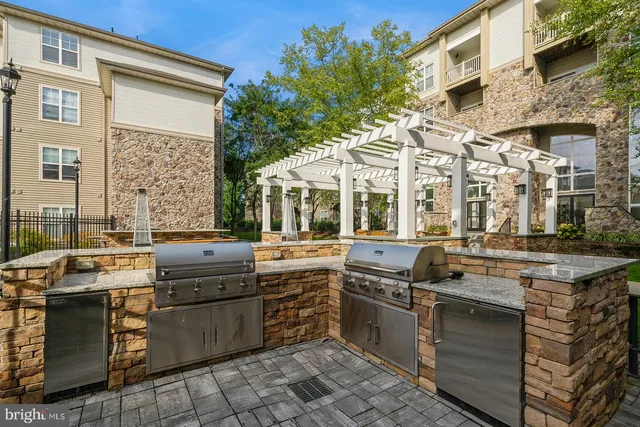 a view of a kitchen with stainless steel appliances granite countertop a stove and a sink
