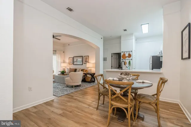 a view of a dining room with furniture and wooden floor
