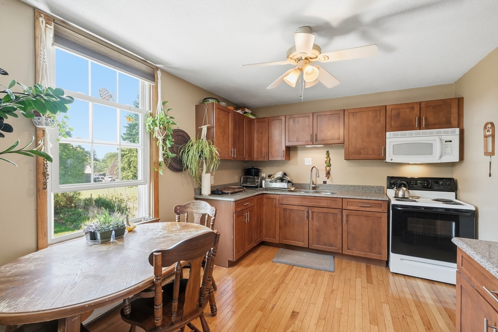15 Main Street Hatfield, MA 01038 - Photo 25 of 42 a kitchen with granite countertop wooden floor stainless steel appliances and dining table
