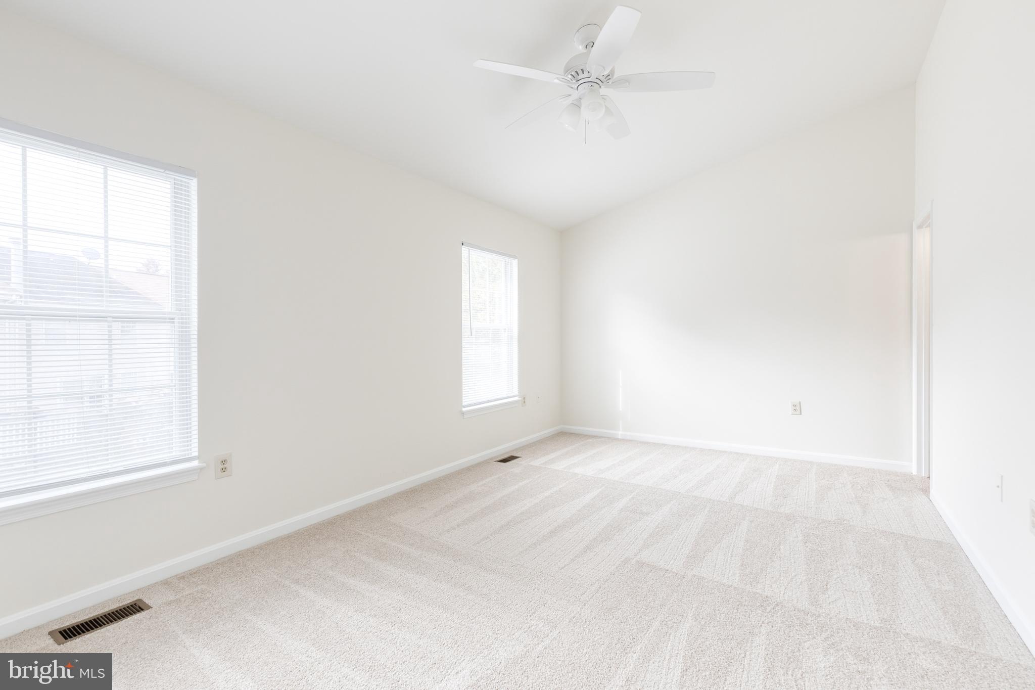 611 Brickston Road Reisterstown, MD 21136 - Photo 11 of 16 an empty room with a window and a fan