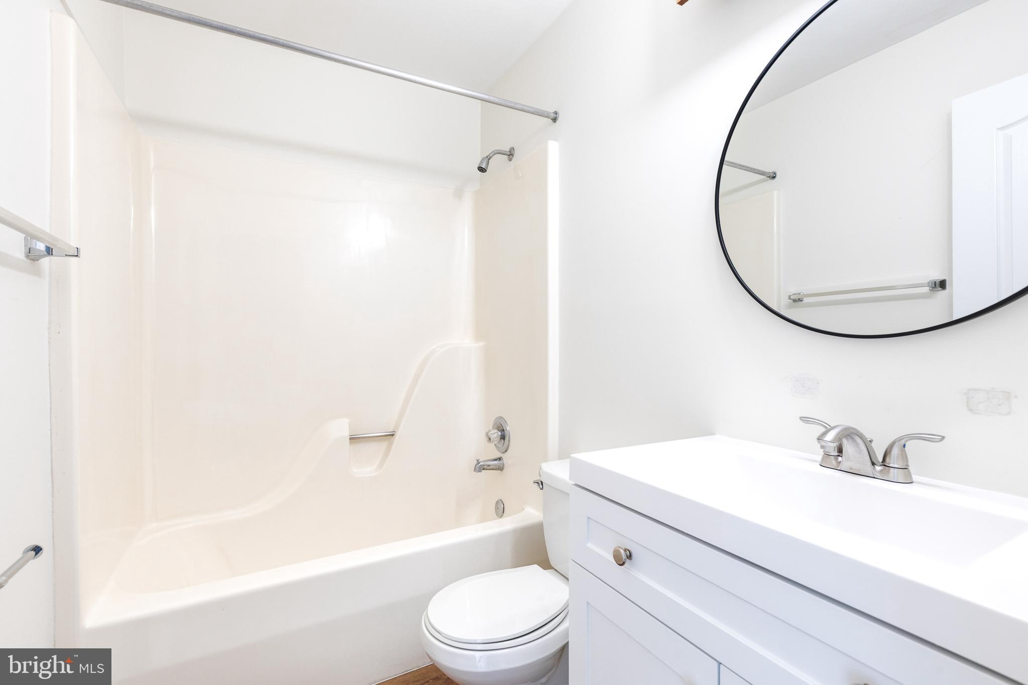 611 Brickston Road Reisterstown, MD 21136 - Photo 14 of 16 a bathroom with a sink a toilet and a mirror