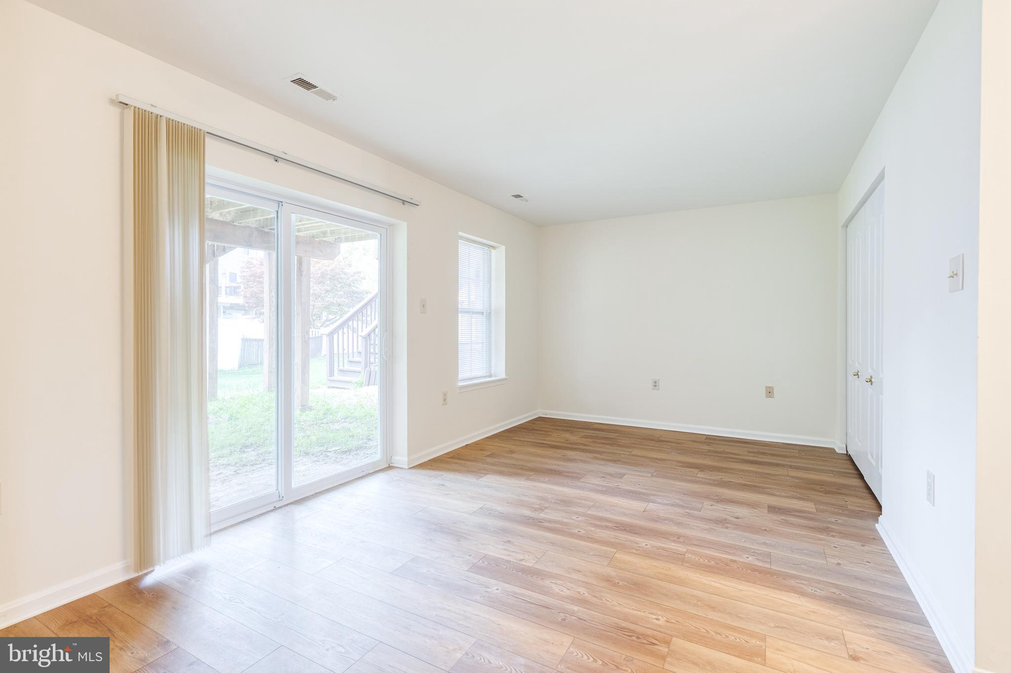 611 Brickston Road Reisterstown, MD 21136 - Photo 2 of 16 a view of an empty room with wooden floor and a window