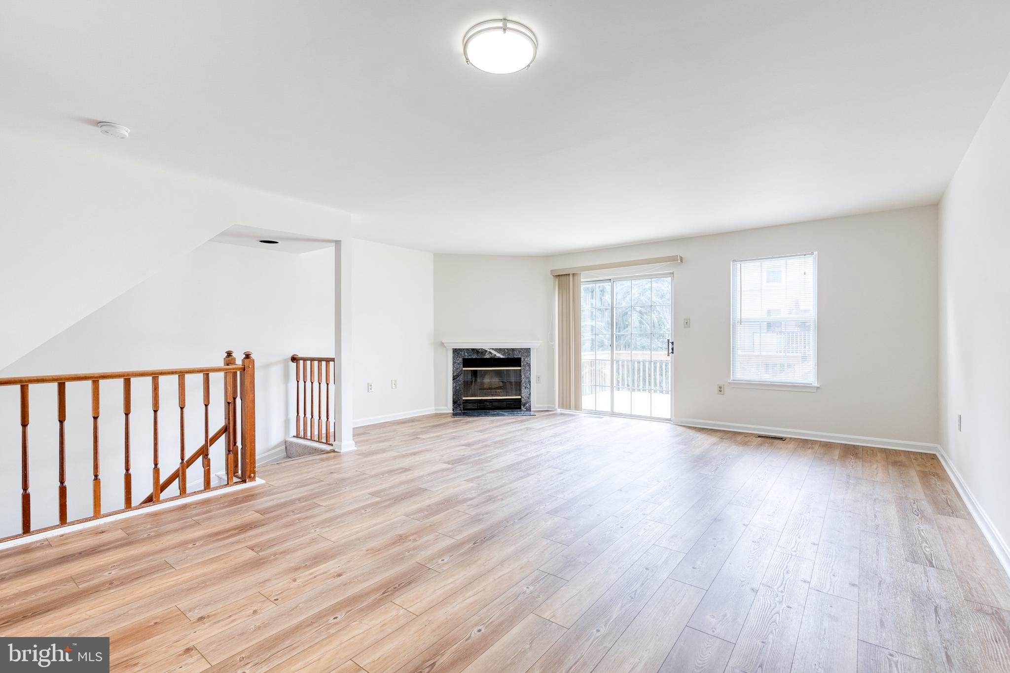 611 Brickston Road Reisterstown, MD 21136 - Photo 4 of 16 a view of an empty room with wooden floor and a window
