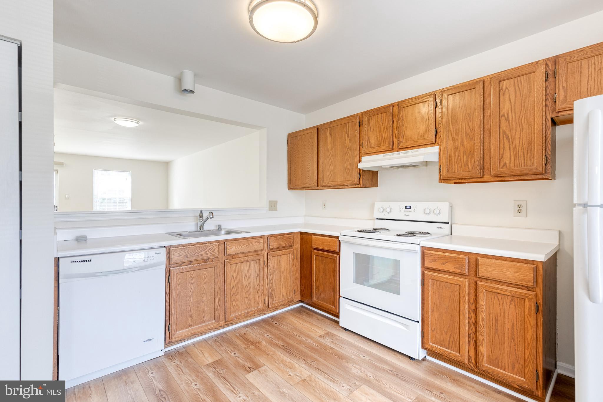 611 Brickston Road Reisterstown, MD 21136 - Photo 8 of 16 a kitchen with granite countertop cabinets stainless steel appliances and a sink
