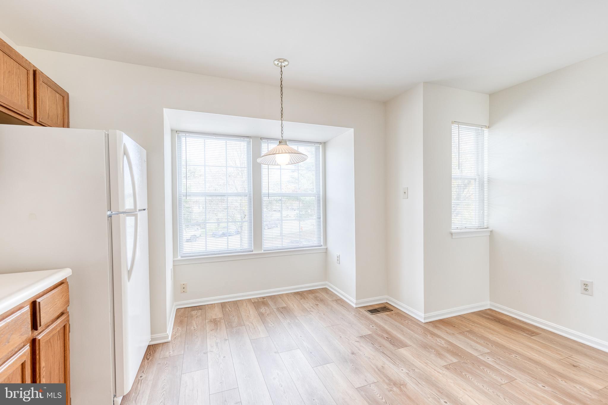 611 Brickston Road Reisterstown, MD 21136 - Photo 9 of 16 a view of an empty room with a window and wooden floor