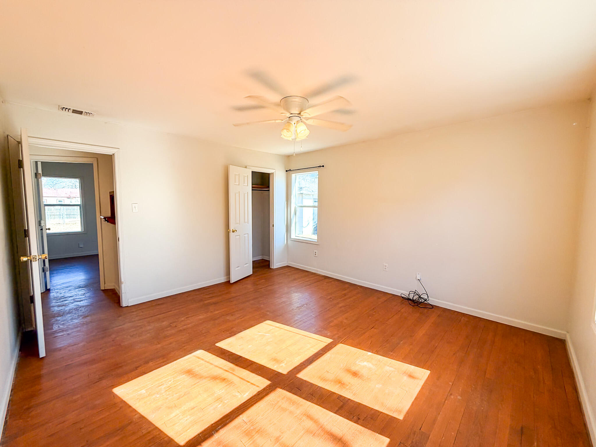 2616 38th Street Lubbock, TX 79413 - Photo 4 of 12 a view of an empty room with window and wooden floor