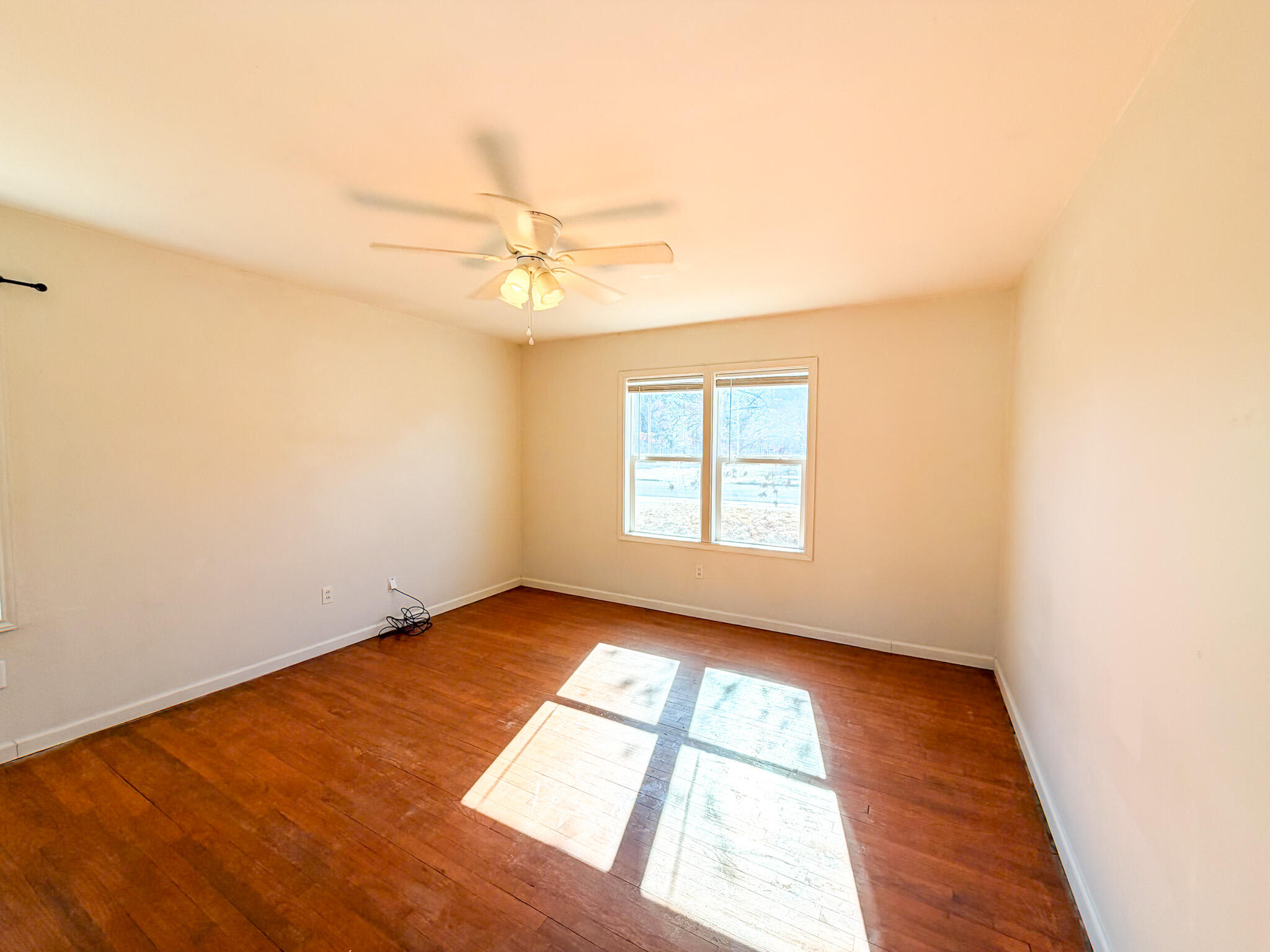 2616 38th Street Lubbock, TX 79413 - Photo 5 of 12 an empty room with wooden floor and windows