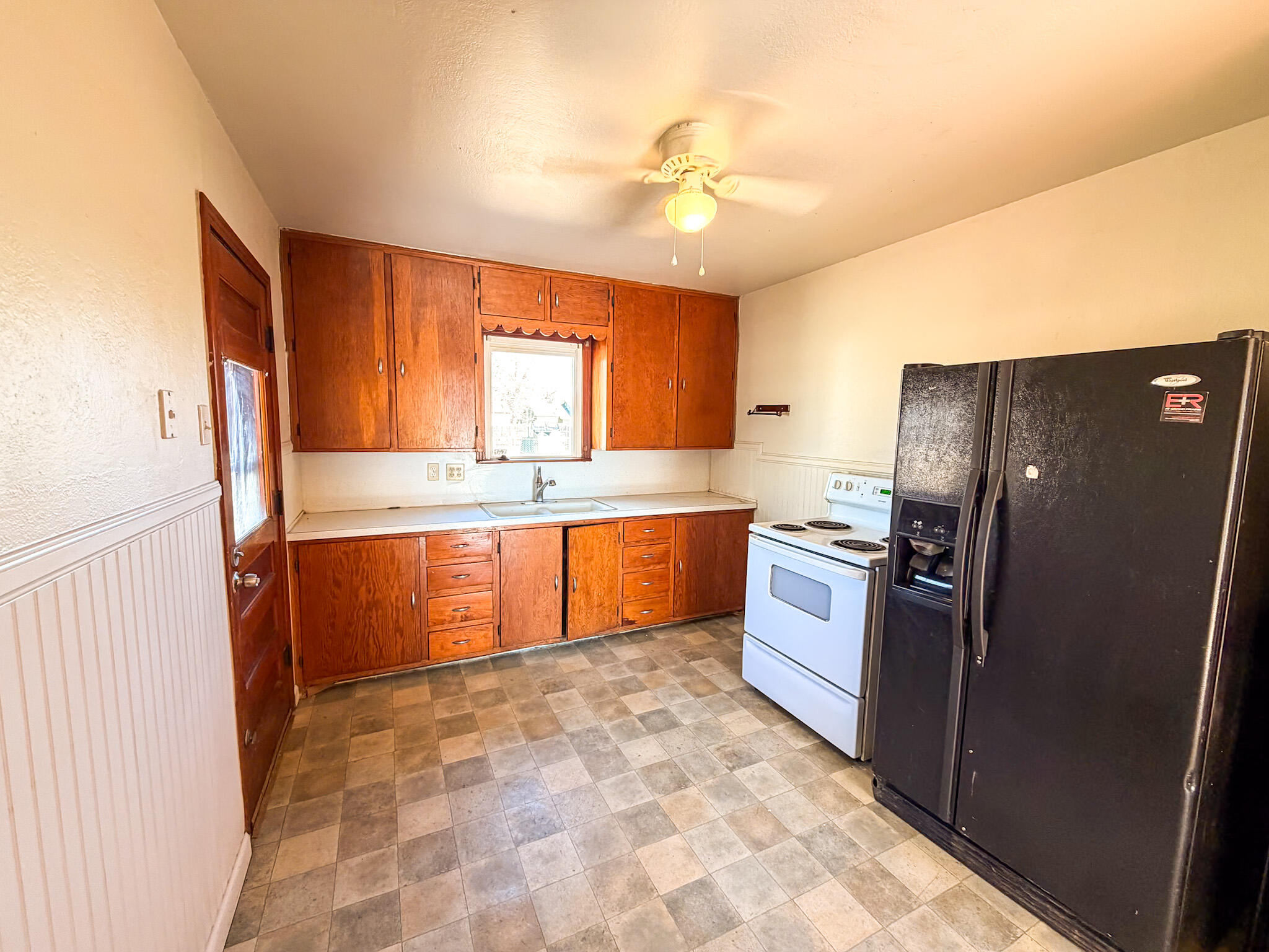 2616 38th Street Lubbock, TX 79413 - Photo 9 of 12 a kitchen with granite countertop a refrigerator and a sink