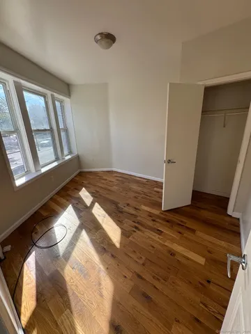 a view of an empty room and wooden floor