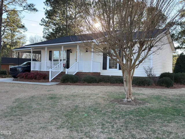 a front view of house with yard and trees