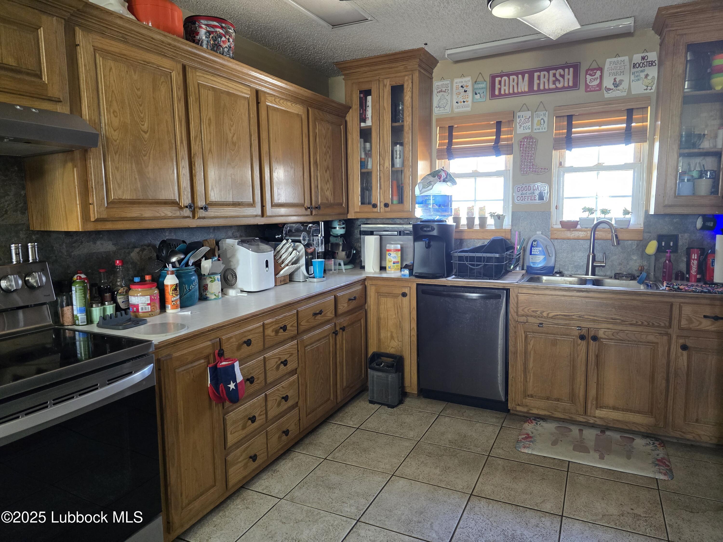 390 County Road Kress, TX 79052 - Photo 11 of 58 a kitchen with cabinets and window