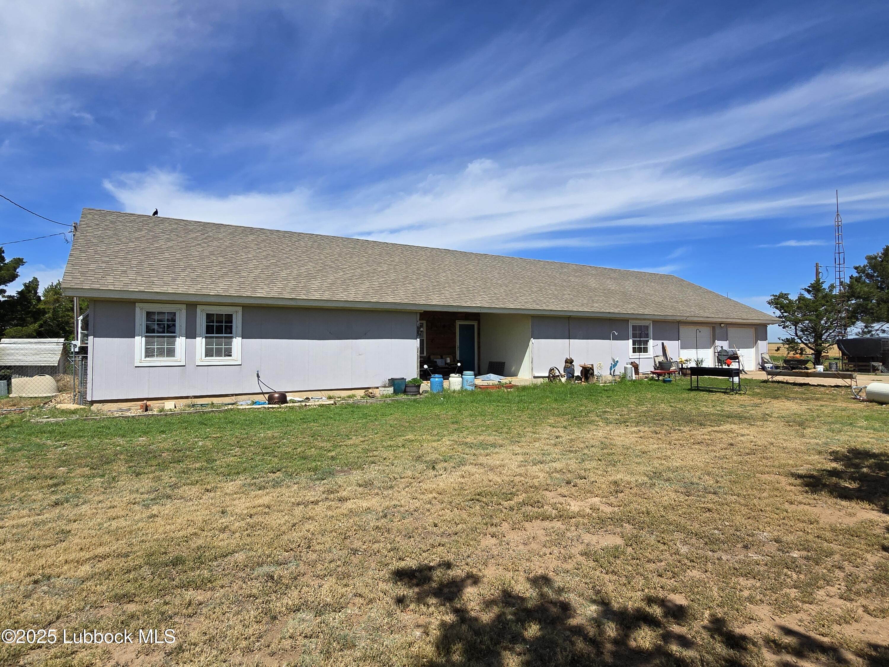 390 County Road Kress, TX 79052 - Photo 2 of 58 a front view of a house with a garden
