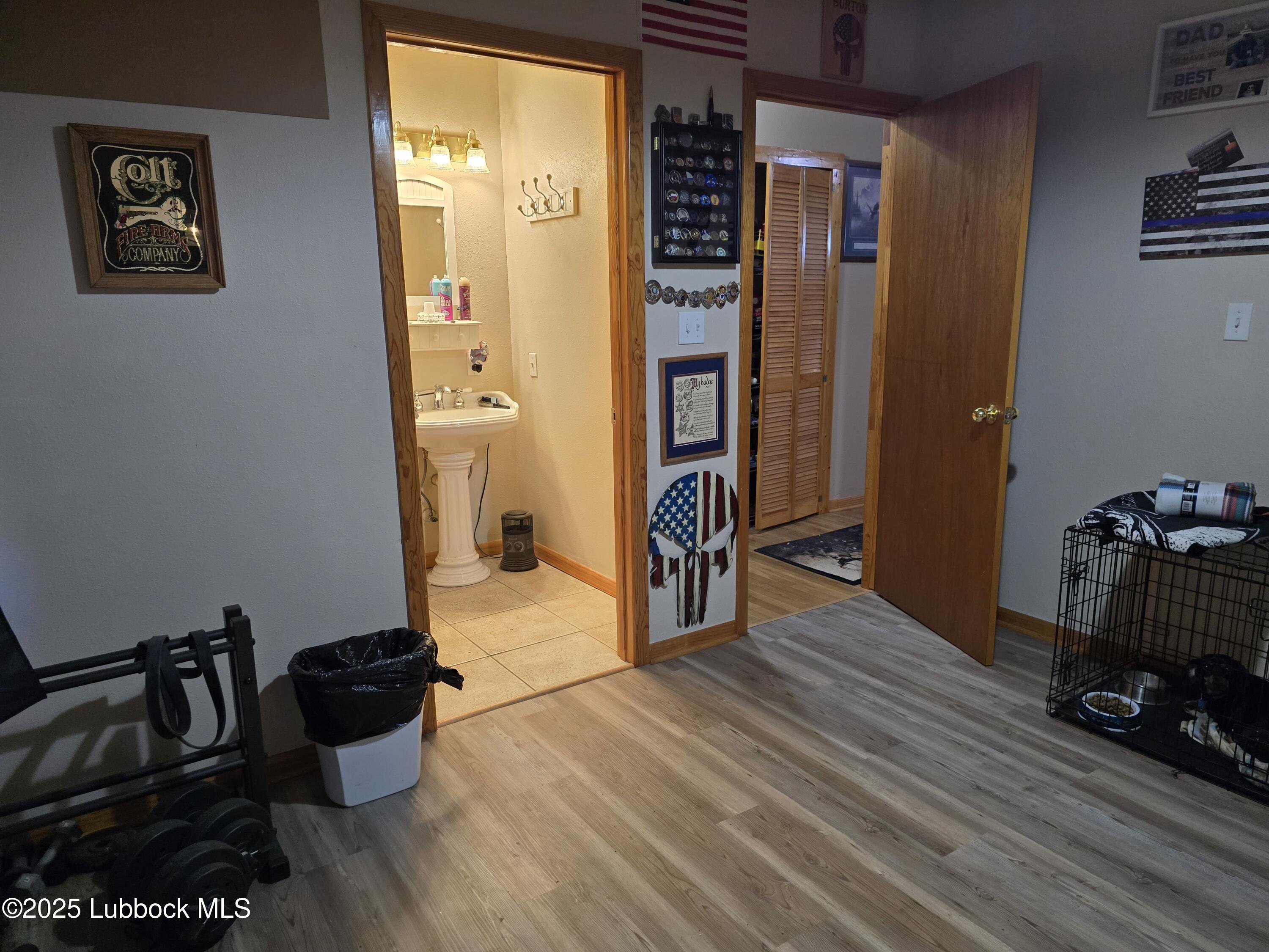 390 County Road Kress, TX 79052 - Photo 22 of 58 a room with wooden floor and furniture