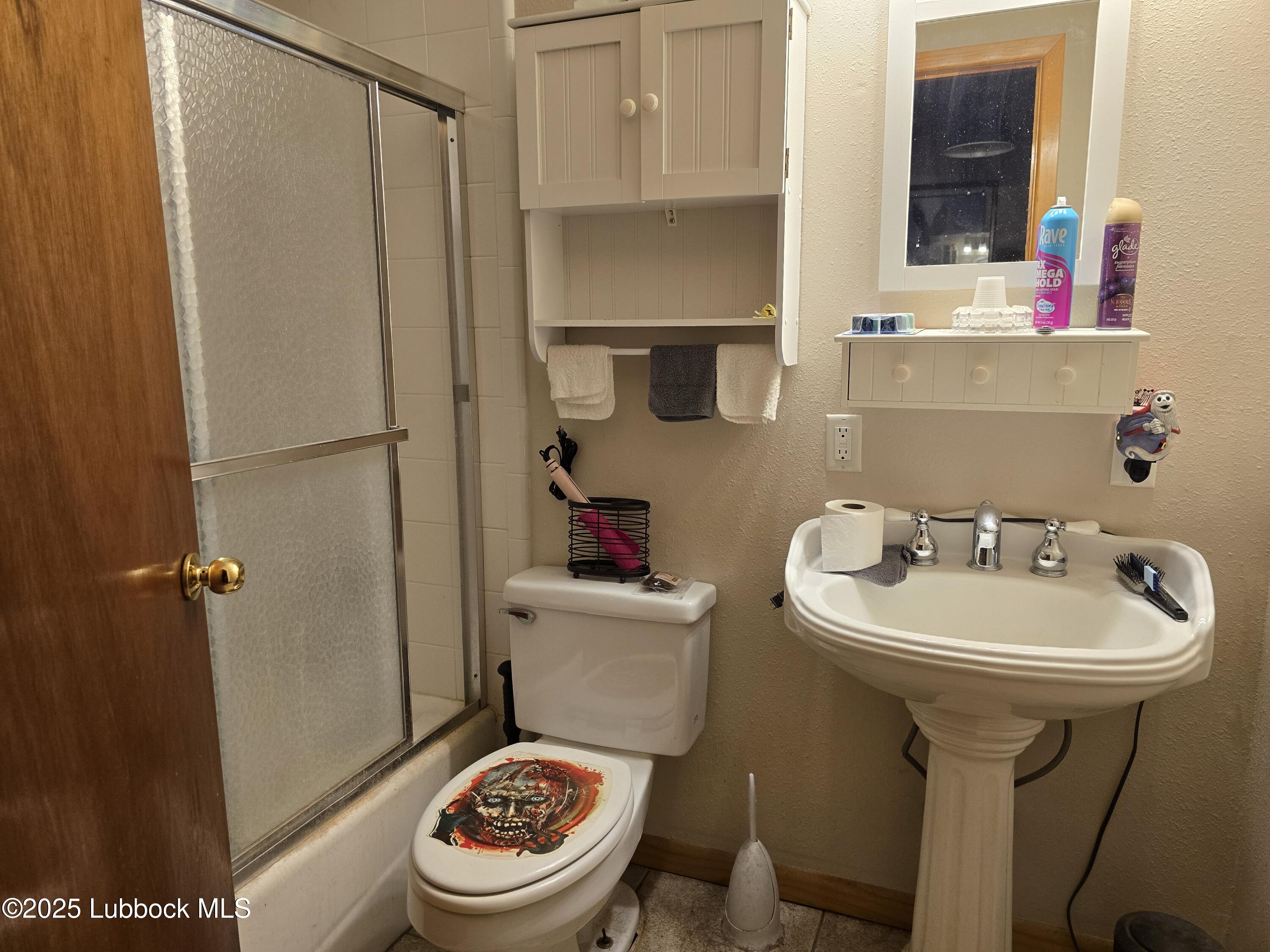 390 County Road Kress, TX 79052 - Photo 23 of 58 a bathroom with a sink toilet and shower
