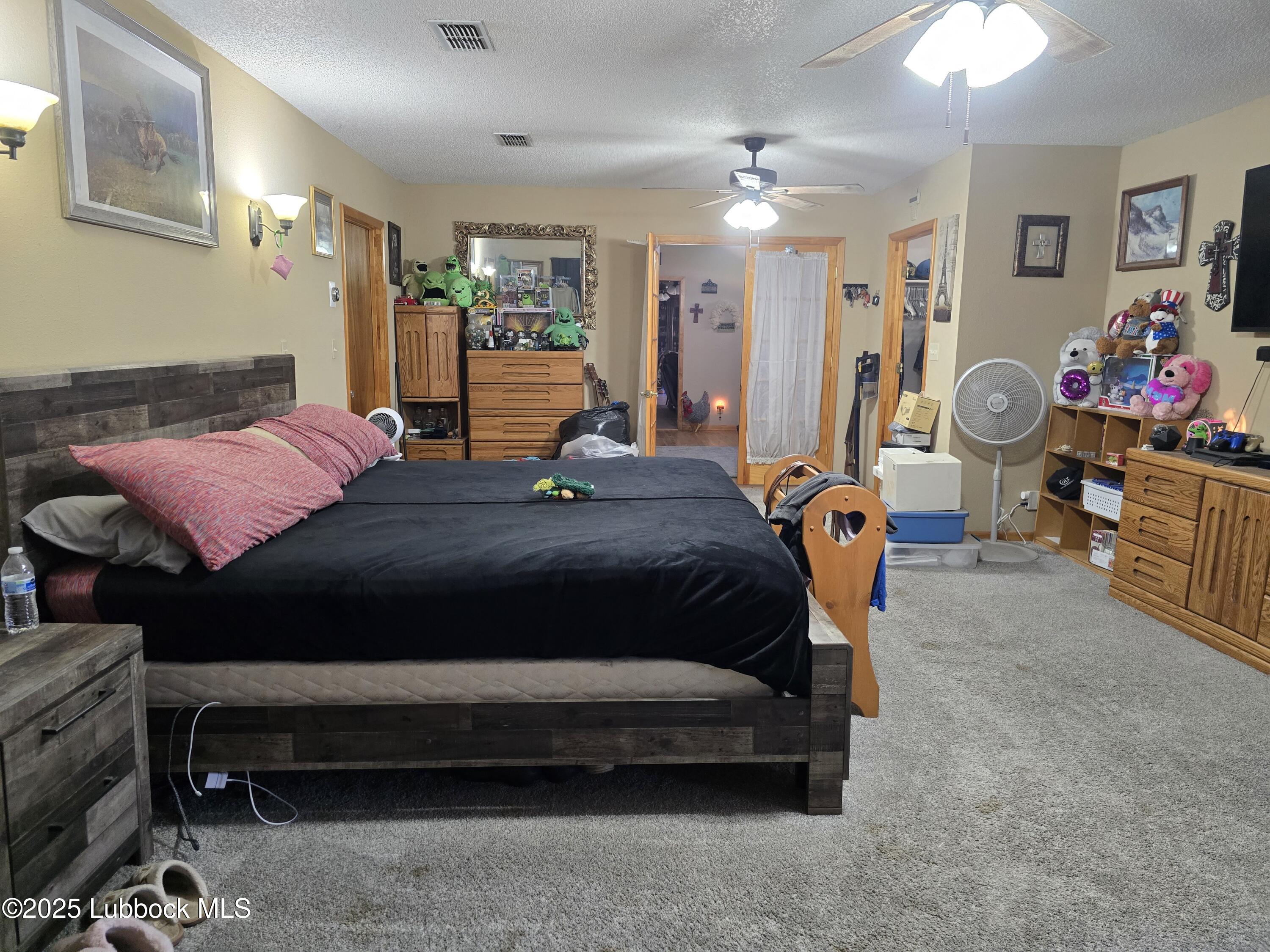 390 County Road Kress, TX 79052 - Photo 26 of 58 a bedroom with a bed gym equipment and view of living room