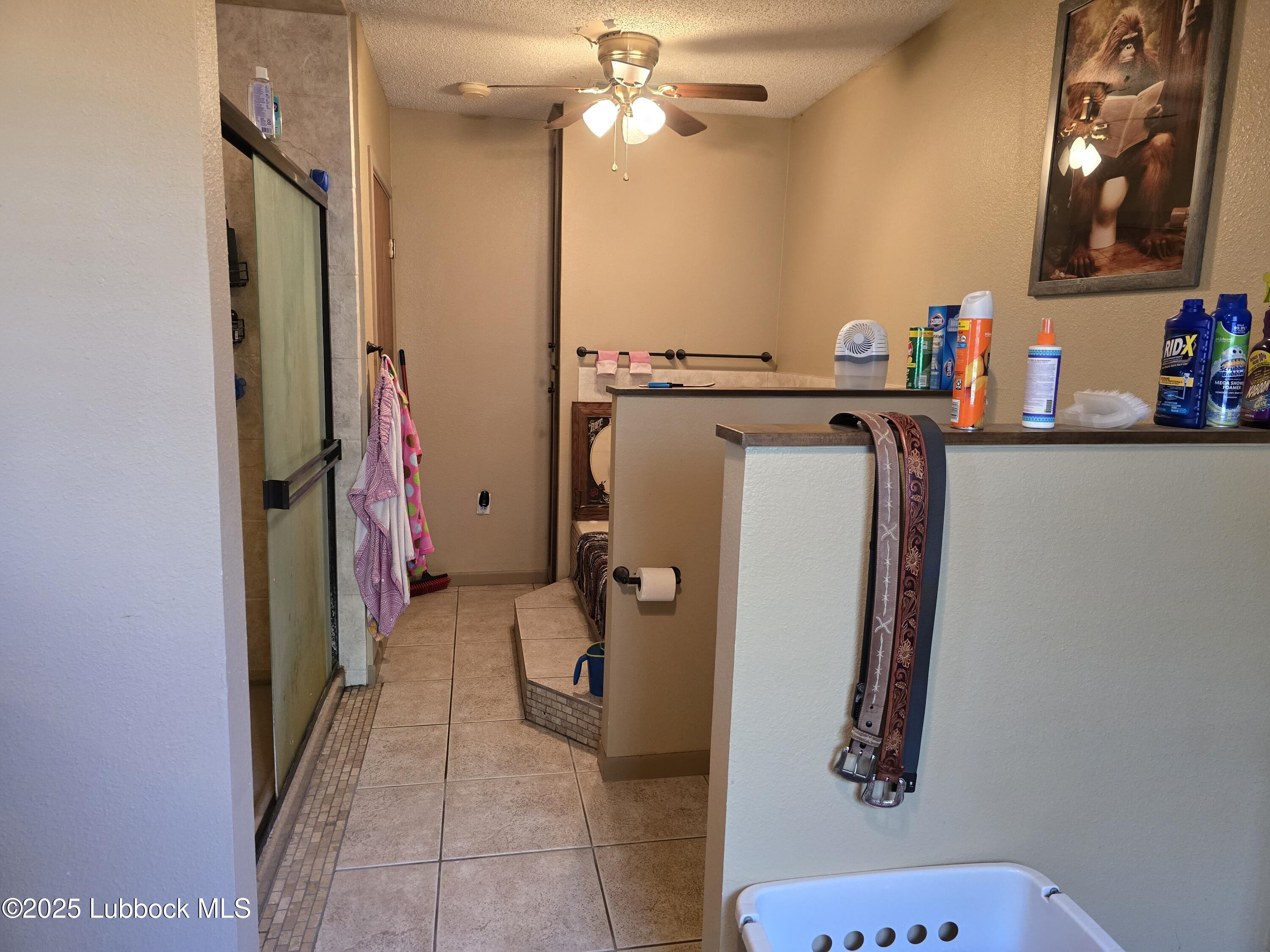 390 County Road Kress, TX 79052 - Photo 28 of 58 a bathroom with a bathtub and a shower