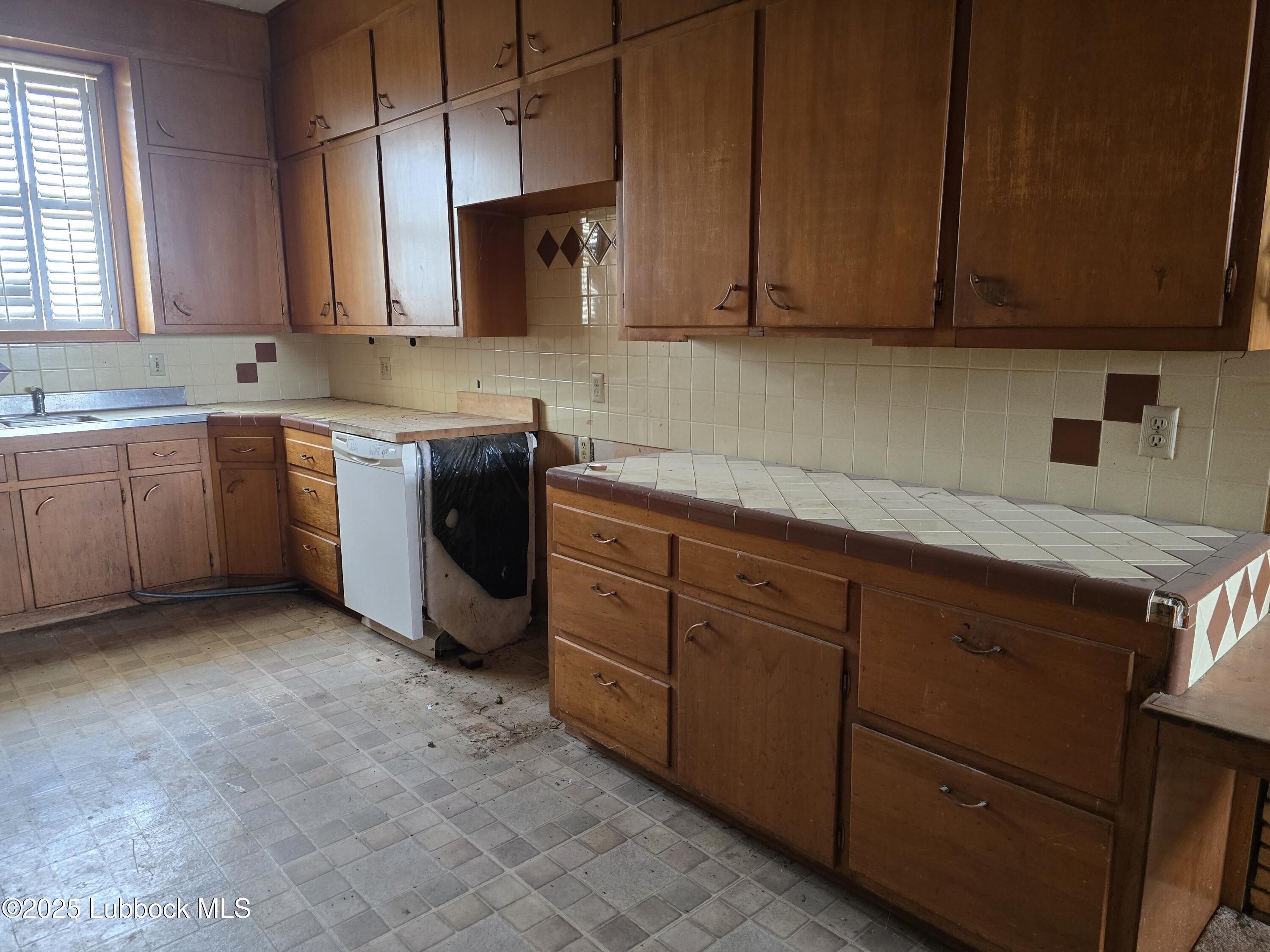 390 County Road Kress, TX 79052 - Photo 47 of 58 a kitchen with sink cabinets and window