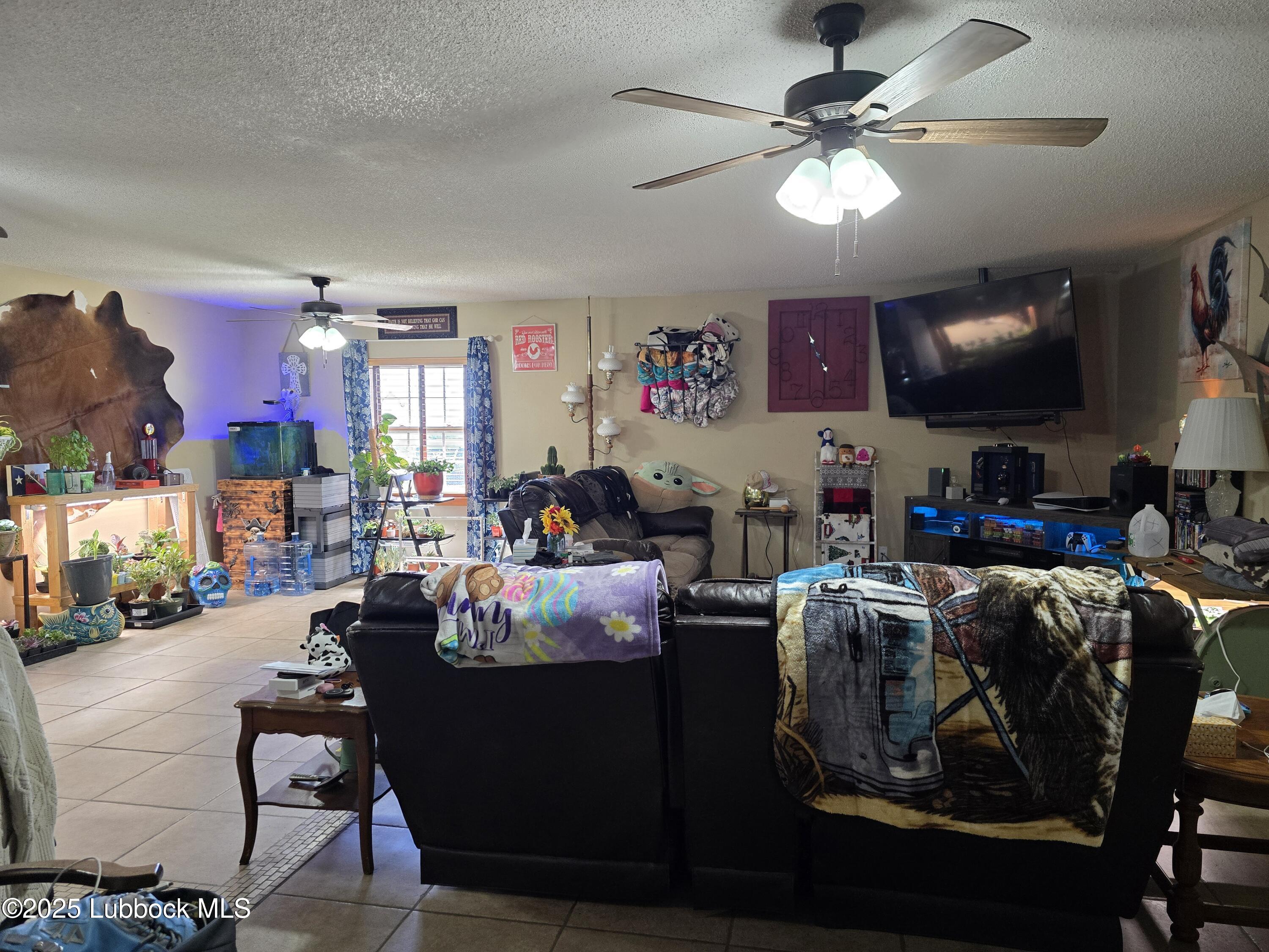 390 County Road Kress, TX 79052 - Photo 6 of 58 a living room with furniture and a flat screen tv