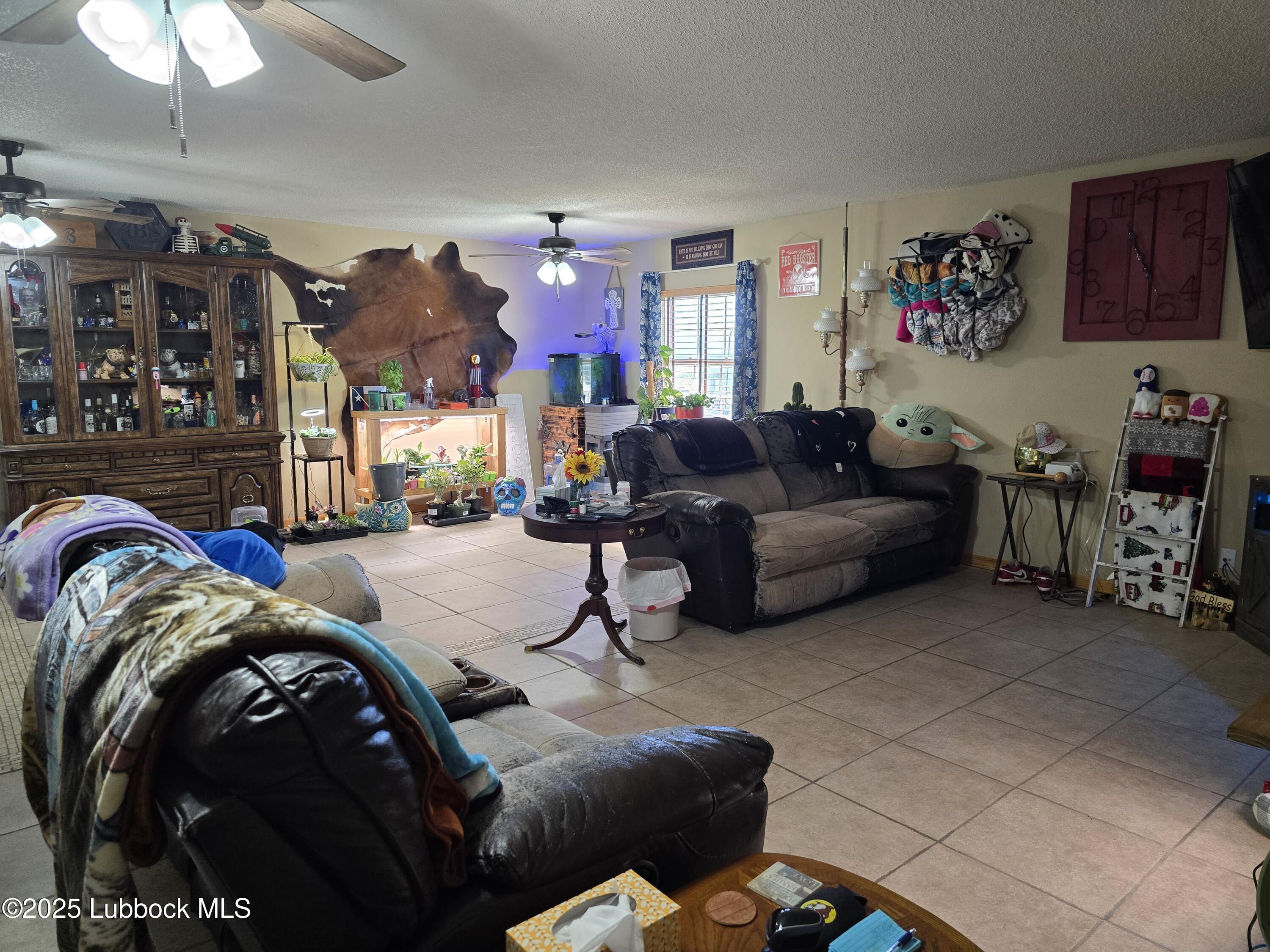390 County Road Kress, TX 79052 - Photo 7 of 58 a living room with furniture and a chandelier