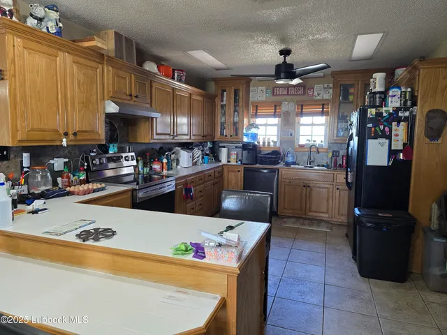 a kitchen with a refrigerator and a stove