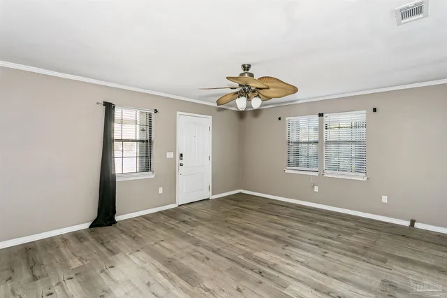 wooden floor in an empty room with a window