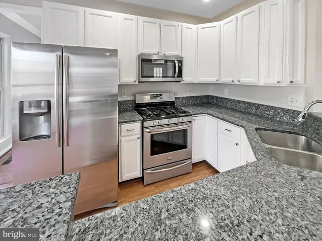 a white toilet sitting next to a bathroom sink