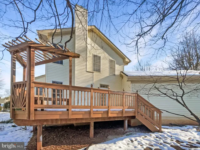 a kitchen with granite countertop a refrigerator and a stove top oven