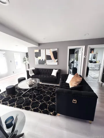 a living room with furniture and a lamp