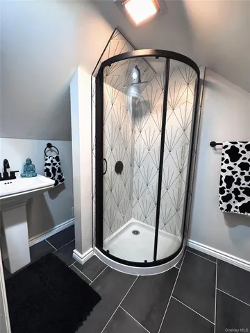 a bathroom with a mirror and a shower