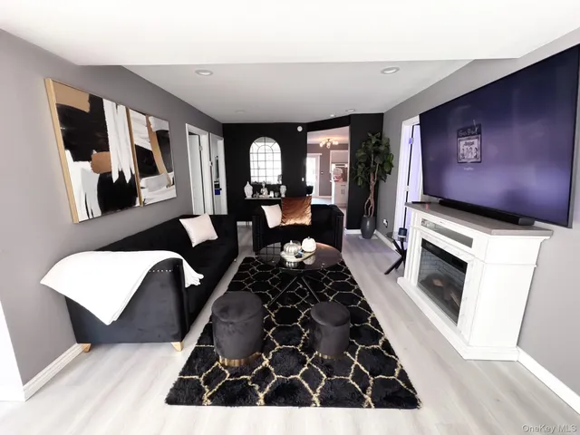 a living room with furniture fireplace and flat screen tv