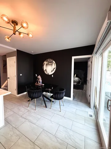 a lobby with furniture and a chandelier