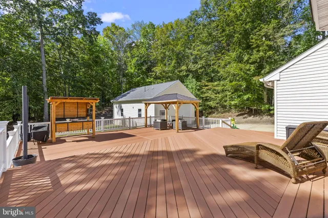 a view of a house with pool and sitting area