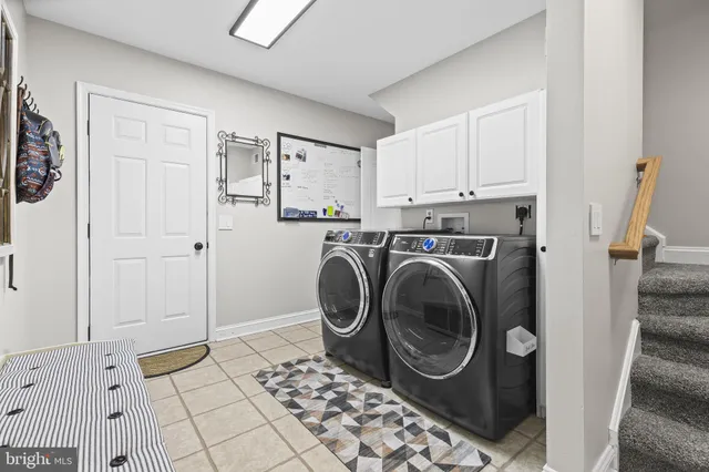 a view of a hallway with washer and dryer