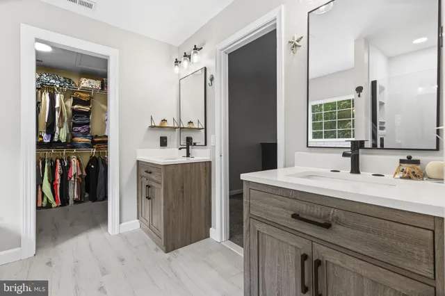 a bathroom with a sink vanity and mirror