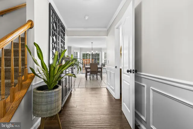 a view of a hallway with wooden floor and windows