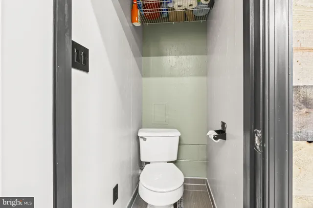 a white toilet sitting in a bathroom next to a sink